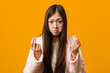 © Asier - Young chinese woman in pajama showing that he has no money.