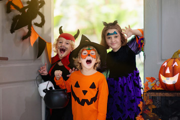 Kids trick or treat. Halloween. Child at door.