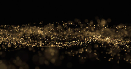 Aufkleber - Gold glitter, light particles wave splash on black background. Shining gold sparks, shimmering sparkles glow, magic bright glitter with bokeh effect