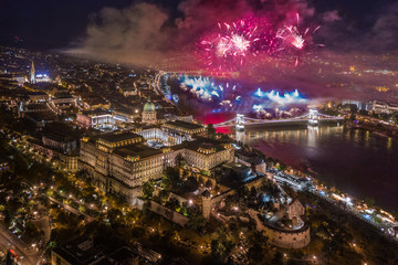 Wall Mural - Budapest, Hungary - Aerial panoramic view of the illuminated Buda Castle Royal Palace and Szechenyi Chain Bridge with fireworks by night