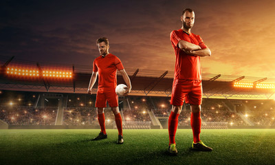 two professional soccer players on the field ready for the game. stadium with spectators