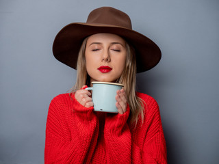 Wall Mural - woman in red sweater and hat with cup of coffee