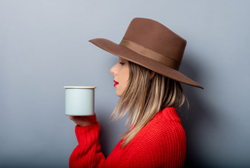 Sticker - woman in red sweater and hat with cup of coffee