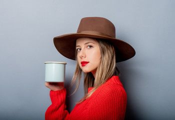 Poster - woman in red sweater and hat with cup of coffee