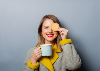 Sticker - style woman in coat with cup of coffee and cookie