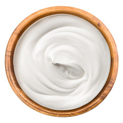 Wall Mural - sour cream in wooden bowl, mayonnaise, yogurt, isolated on white background, clipping path, full depth of field