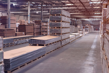 Wall Mural - Production line of the wooden floor factory. Warehouse of boards in the production. Pile of cut wood in factory storage warehouse.Lumber in warehouse.