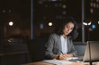 © mavoimages - Young businesswoman working in her office at night