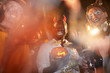 © Seventyfour - Low angle view at group of adult men wearing Halloween costumes posing during party in club, focus on African-American man holding pumpkin in center