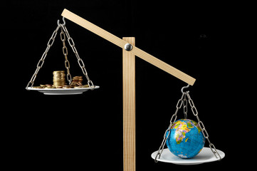 Earth and Money on a Two Pan Balance