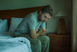 © TheVisualsYouNeed - dramatic lifestyle portrait of handsome guy sitting on bed feeli