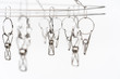 © DG PhotoStock - Stainless steel clothespins close up, household equipment.