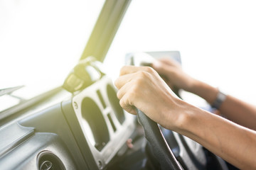 Man holding car steering wheel close up.  Concept of safe driving and automobile care.