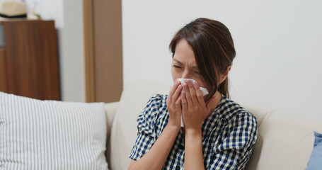 Wall Mural - Woman suffer from influenza, sneeze at home