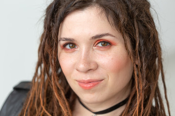 Fashion and beauty concept - portrait of young stylish woman with dreadlocks