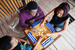 © AS Photo Family - Group of three african american friends play table games.
