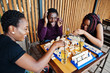 © AS Photo Family - Group of three african american friends play table games.