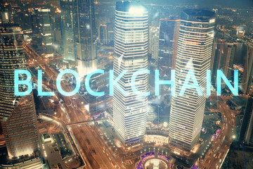 Multi exposure of cryptocurrency theme hologram drawing and city veiw background. Concept of blockchain and bitcoin.