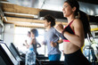 © NDABCREATIVITY - Fit people running in machine treadmill at fitness gym