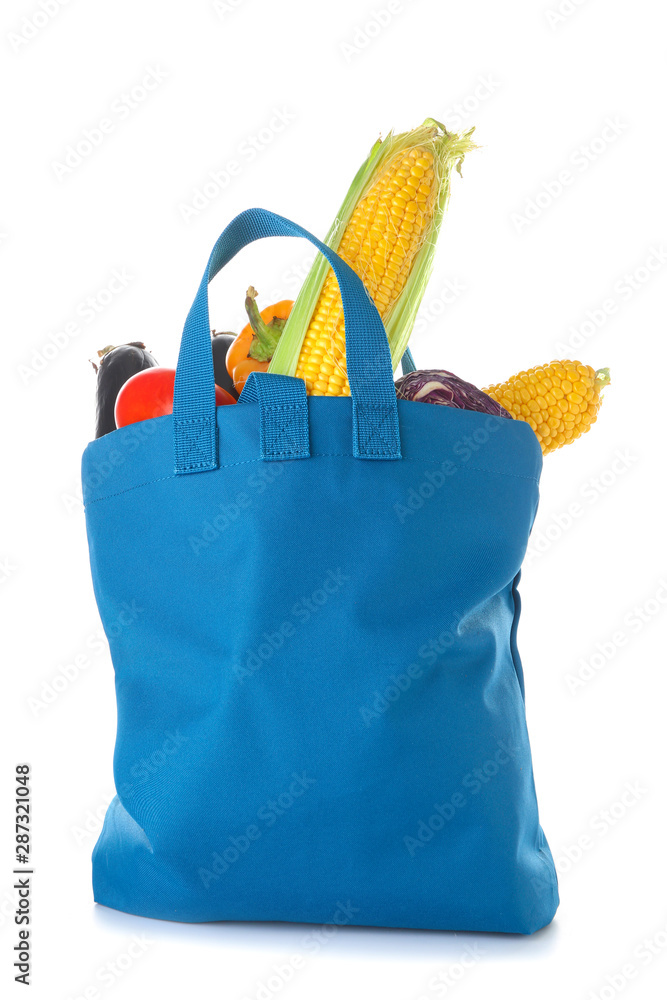 Stylish eco bag with fresh vegetables on white background