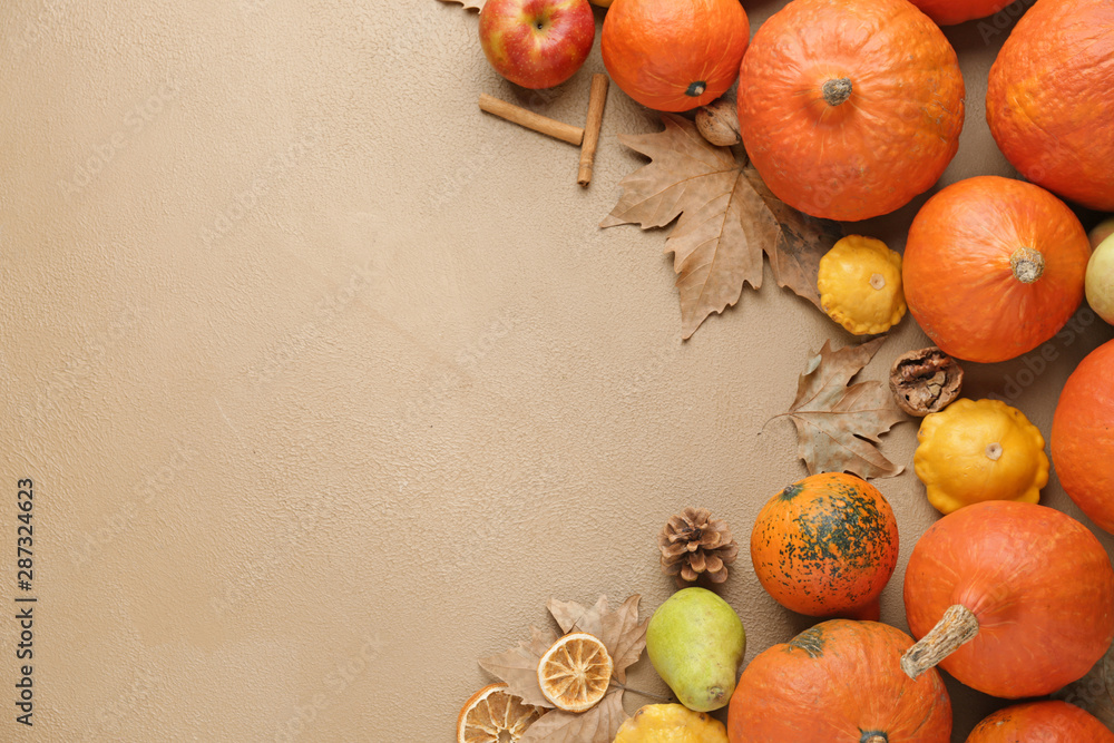 Autumn composition with fresh pumpkins on color background