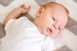 © Pixel-Shot - Cute little baby lying on bed