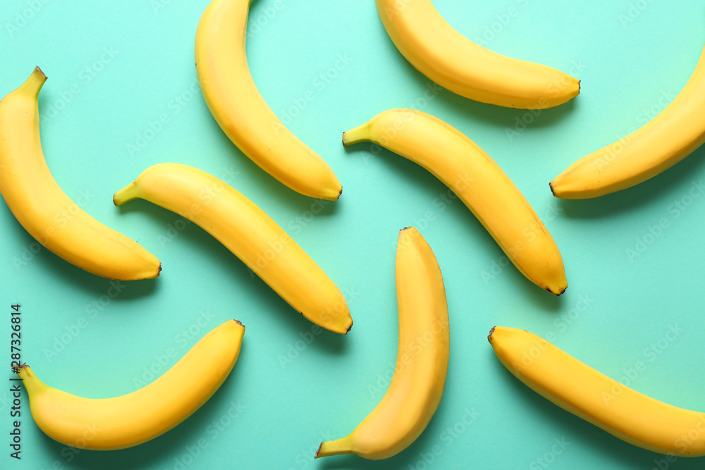 Many sweet ripe bananas on color background