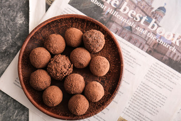 Wall Mural - Plate with tasty sweet truffles on table