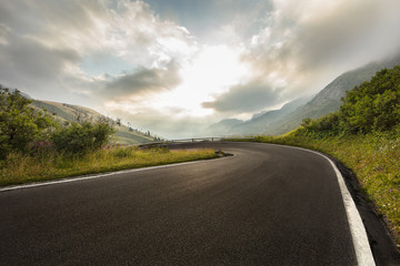 Wall Mural - Asphalt road in Dolomites in a summer day, Italy.
