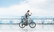 © adam121 - Businessman with megaphone in hand on bike