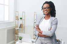 Happy African American Businesswoman Sitting On Office Table Indoor
