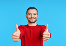 Happy Handsome Man Showing Thumbs Up Sign On Blue Background