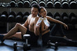 © Blanscape - couple clink bottle of water after dumbbell exercise