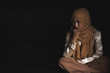 © rachaphak - Young Muslim women sitting and feeling pain.. Lonely Muslim girl harly thinking how to solve life problem.
