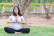 © reewungjunerr - Portrait of asian Beautiful pregnant woman at the park,Thailand people,Happy woman concept,Her play yoga on the lawn
