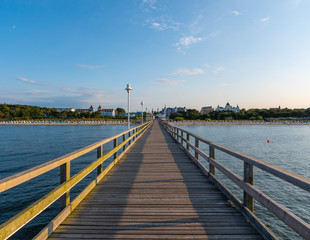 Canvas Print - Footbridge on the beach with village