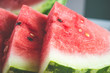 Close up of triangular slices of ripe fresh watermelon with red flesh. Selective focus