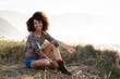 © Dirima - Pretty afro hairstyle woman relaxing on summer trip to the coast. Asturias, Spain.