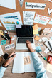 © LIGHTFIELD STUDIOS - top view of businesswoman holding pen near notebook and gadgets with blank screens