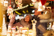 © Syda Productions - shopping, winter holidays and people concept - happy senior couple at christmas market souvenir shop on town hall square in tallinn, estonia
