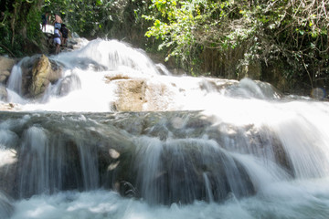 Wall Mural - Flowing river falls over limestone