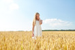 © Syda Productions - nature, harvest and people concept - smiling young girl on cereal field in summer
