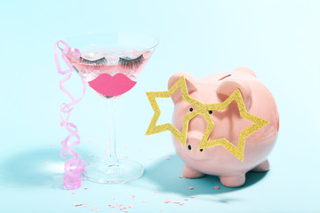 Sticker - Piggybank with cocktail in glass on blue background. Minimalism concept