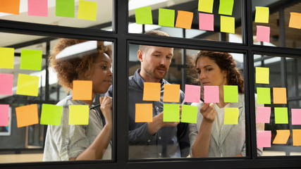 Wall Mural - diverse business team brainstorm on project strategy with sticky notes