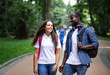 © proimagecontent - A pair of multicultural students enjoying their walk through the campus park