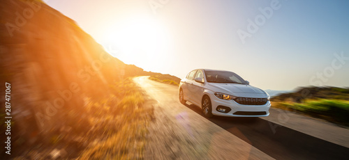 Fotografía rental car in spain mountain landscape road at sunset