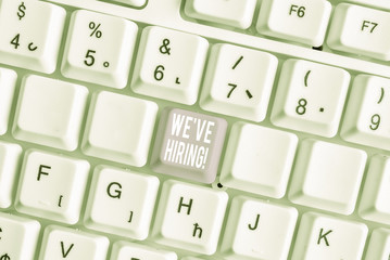 Word writing text We Are Hiring. Business photo showcasing recently you employ someone or pay someone to do particular job White pc keyboard with empty note paper above white background key copy space