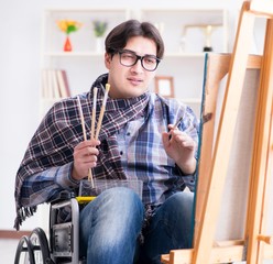 Disabled artist painting picture in studio