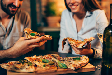 Wall Mural - close up of people eating pizza