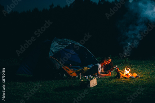 Romantic Couple On Night Camping Reading Book Night Scene With Camping Fire Buy This Stock Photo And Explore Similar Images At Adobe Stock Adobe Stock